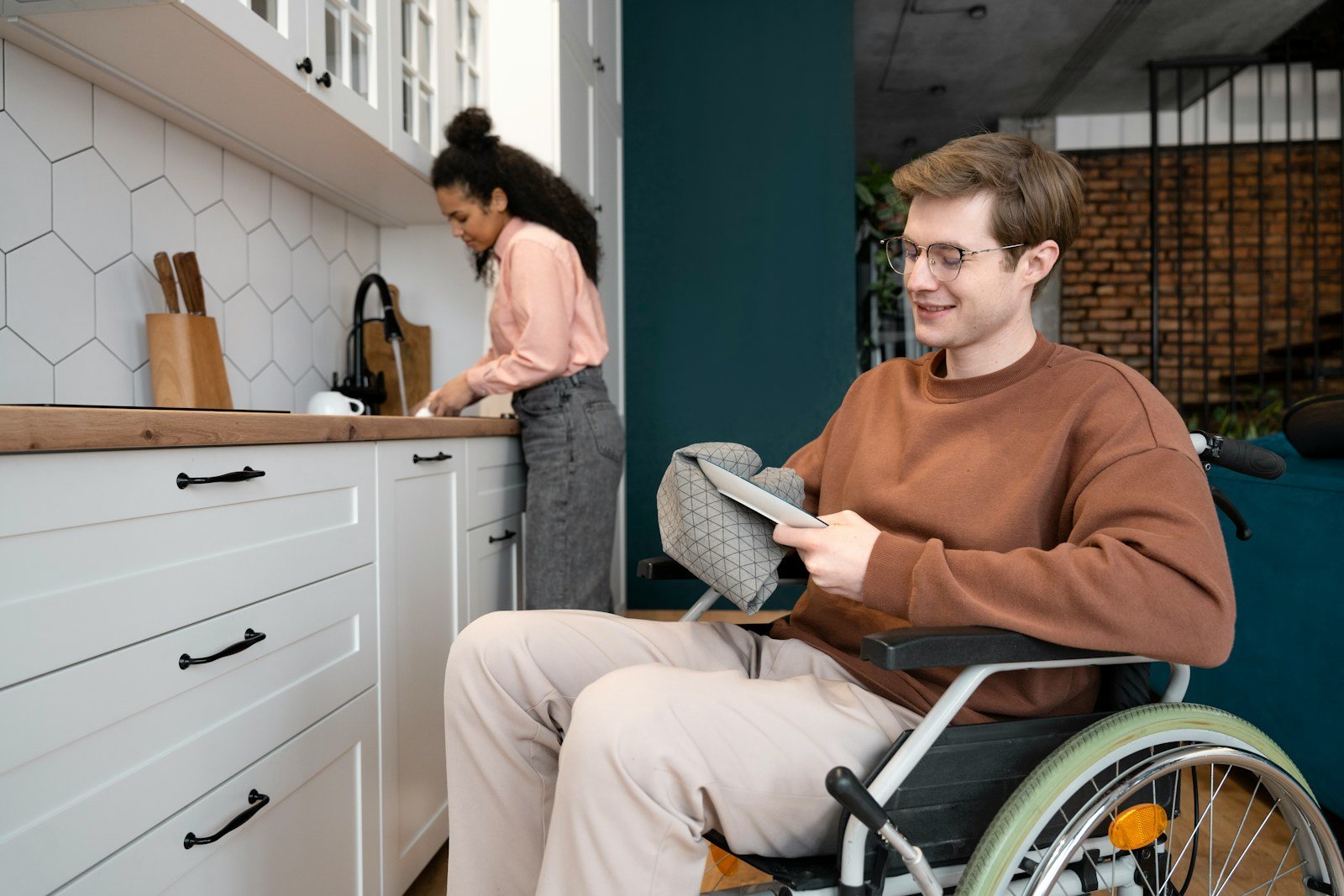 A man in a wheel chair in a kitchen
