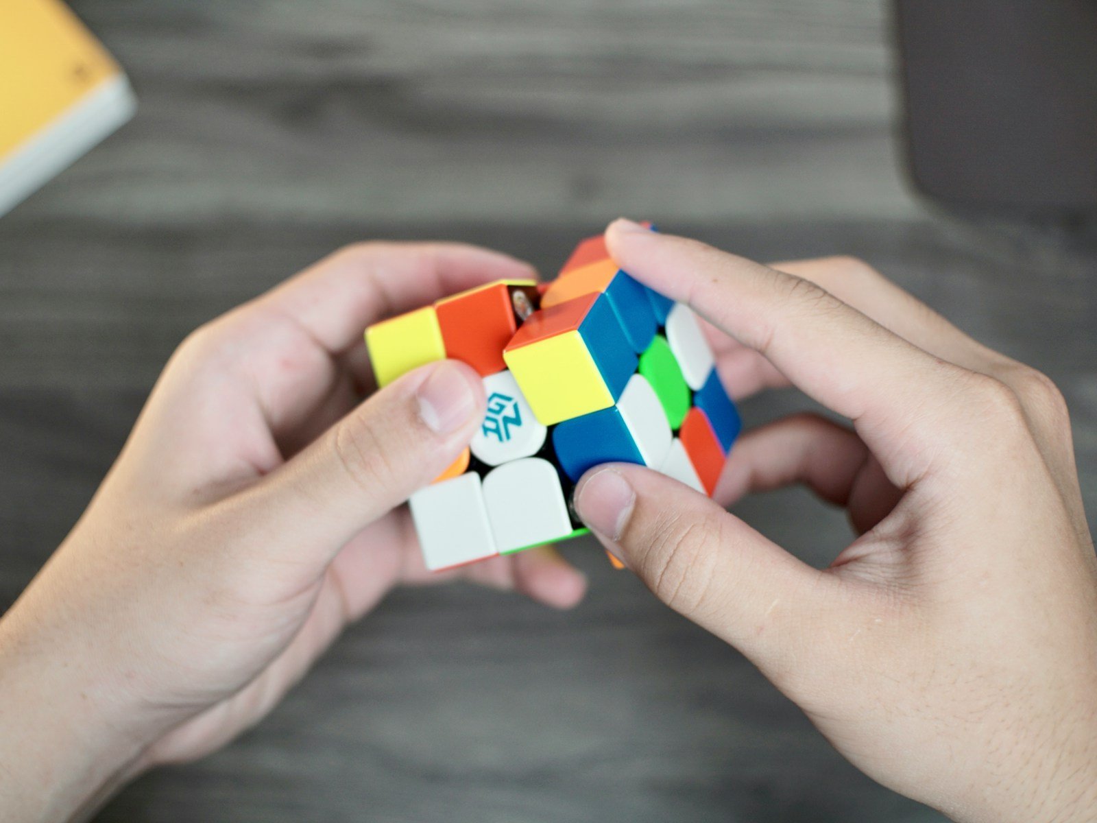 a person holding a rubik cube in their hands